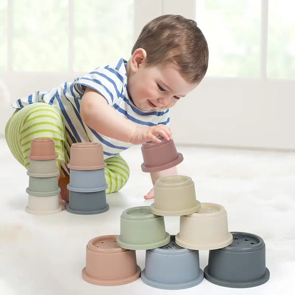 baby playing with stack cup plastic